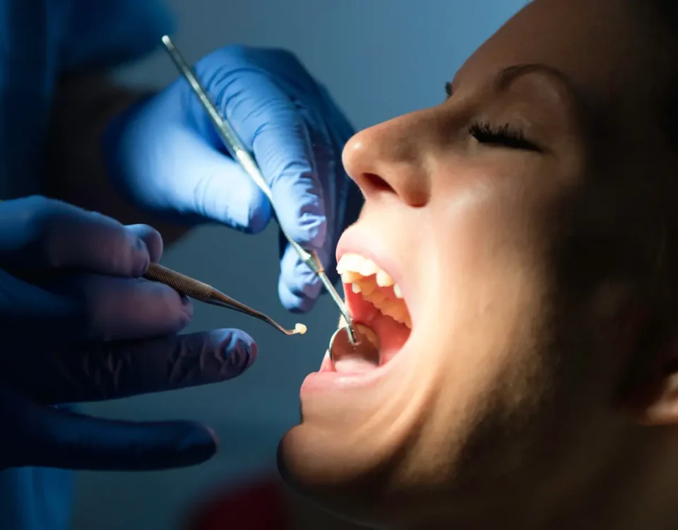 Dentist examining patient for dental filling failure during checkup at Higher Ground Dentistry in Upland California